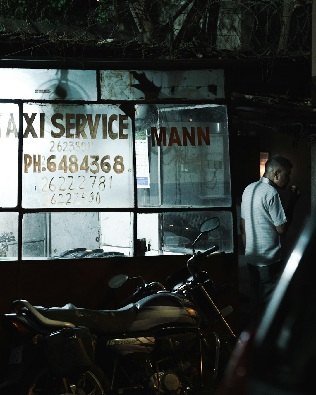 man-in-white-dress-shirt-standing-beside-black-motorcycle-schxzqmy8tk
